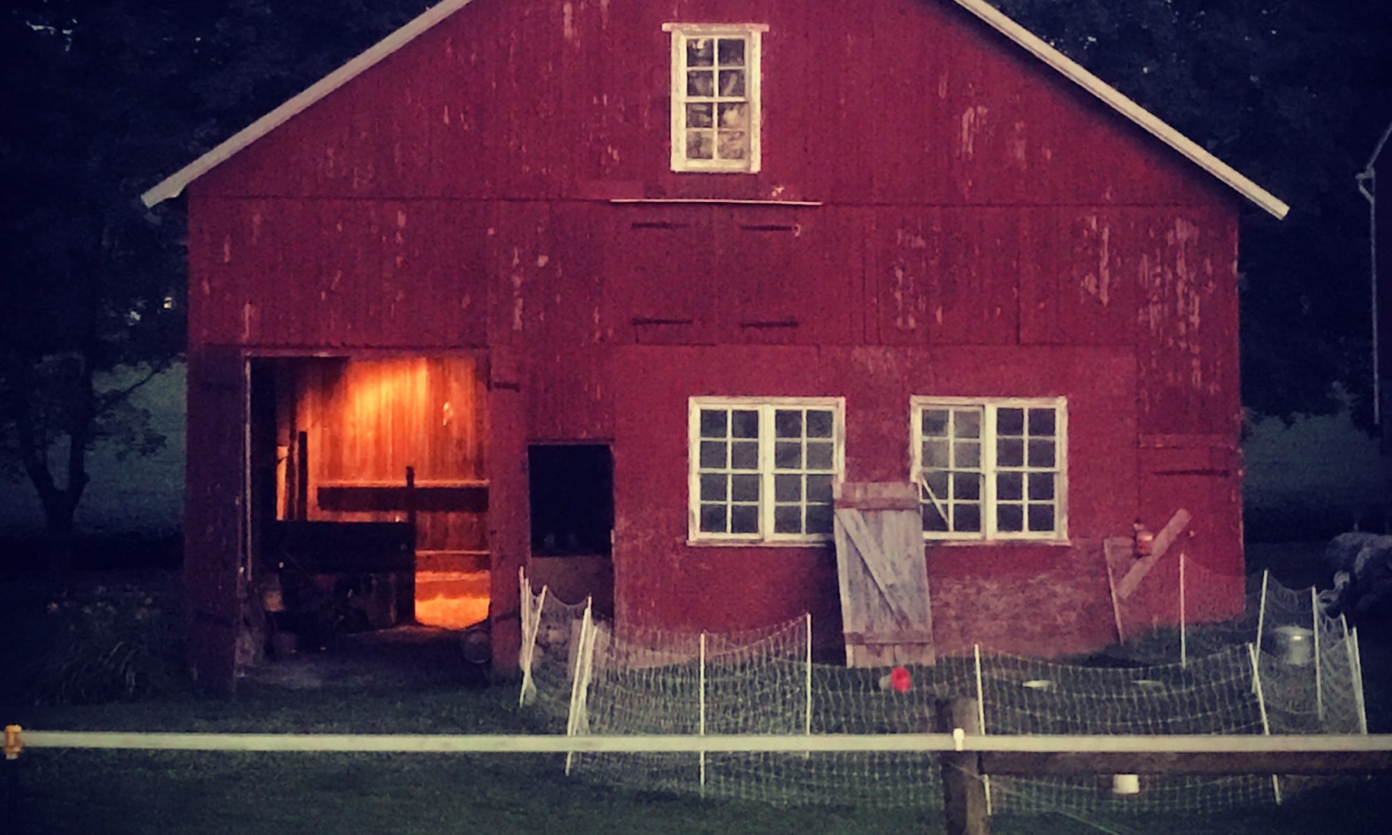 Old PA barn with lights on inside
